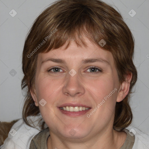 Joyful white young-adult female with medium  brown hair and blue eyes