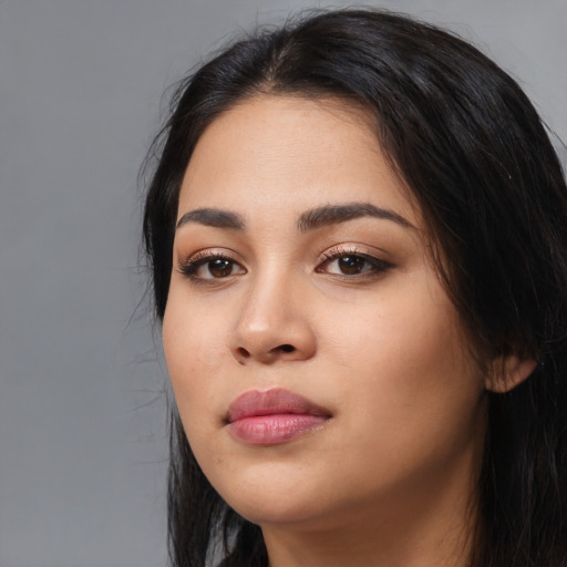 Joyful latino young-adult female with long  black hair and brown eyes