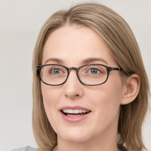 Joyful white young-adult female with medium  brown hair and blue eyes