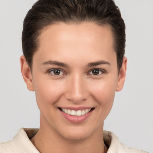 Joyful white young-adult female with short  brown hair and brown eyes