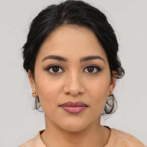 Joyful latino young-adult female with medium  brown hair and brown eyes
