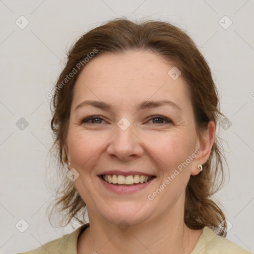 Joyful white adult female with medium  brown hair and grey eyes