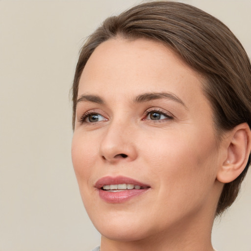 Joyful white young-adult female with medium  brown hair and brown eyes