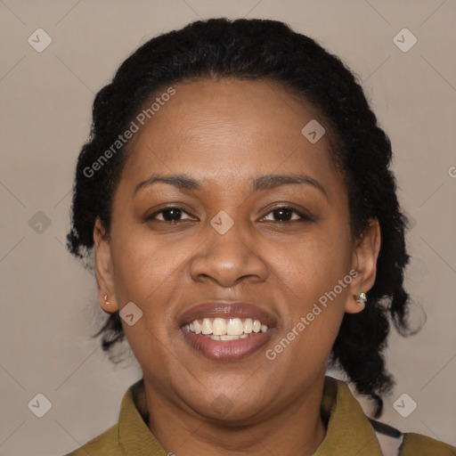 Joyful black adult female with short  brown hair and brown eyes