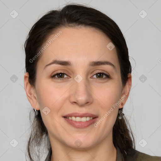 Joyful white adult female with long  brown hair and grey eyes