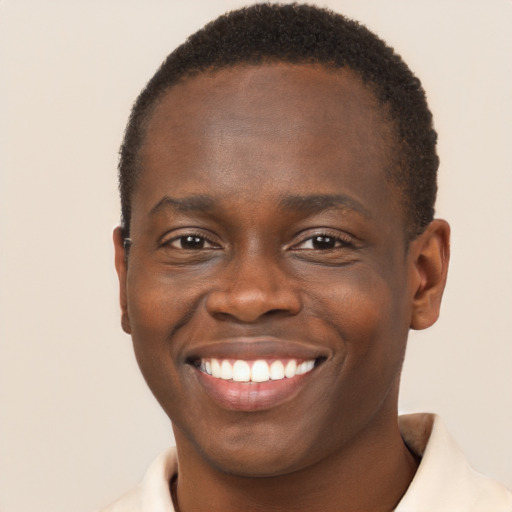 Joyful black young-adult male with short  brown hair and brown eyes