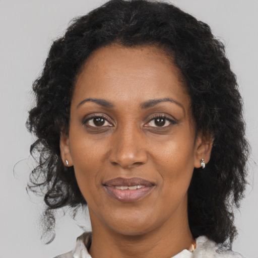Joyful black adult female with medium  black hair and brown eyes
