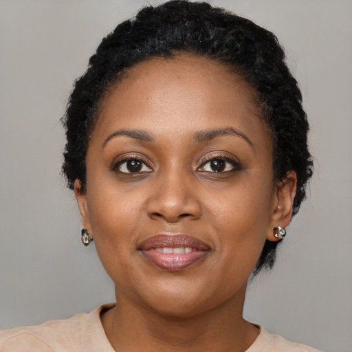 Joyful black young-adult female with short  brown hair and brown eyes