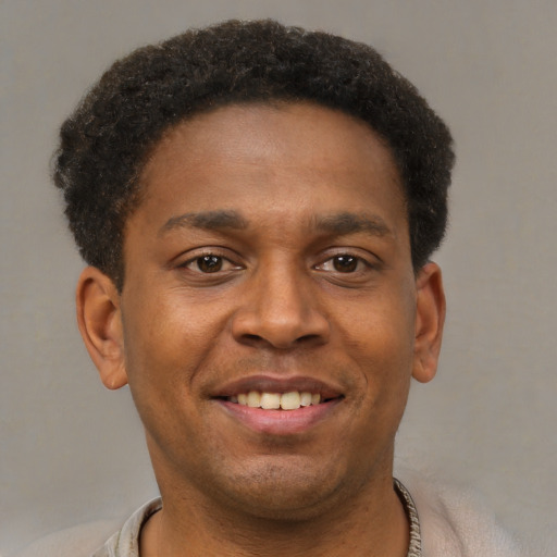 Joyful latino young-adult male with short  brown hair and brown eyes