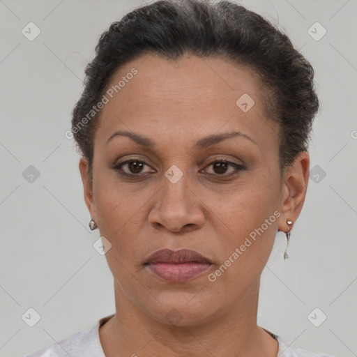 Joyful latino adult female with short  brown hair and brown eyes