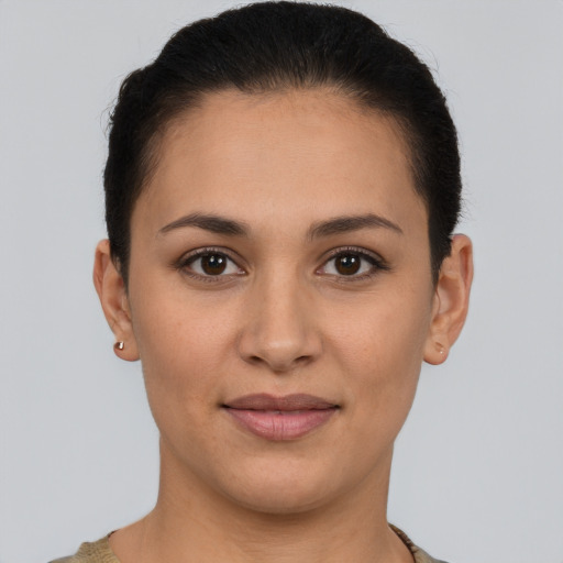 Joyful latino young-adult female with short  brown hair and brown eyes