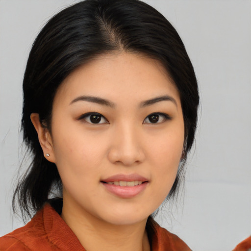 Joyful asian young-adult female with medium  black hair and brown eyes