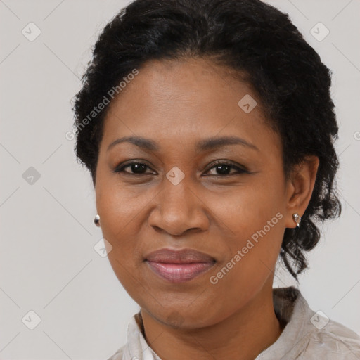 Joyful black adult female with short  black hair and brown eyes