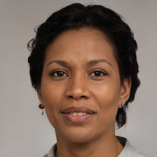 Joyful black adult female with short  black hair and brown eyes
