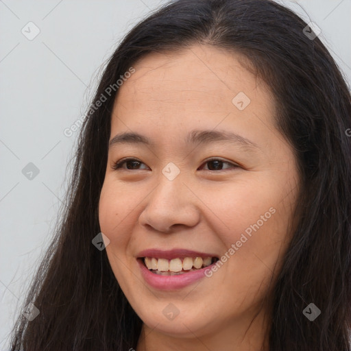 Joyful white young-adult female with long  brown hair and brown eyes