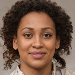 Joyful black adult female with medium  brown hair and brown eyes