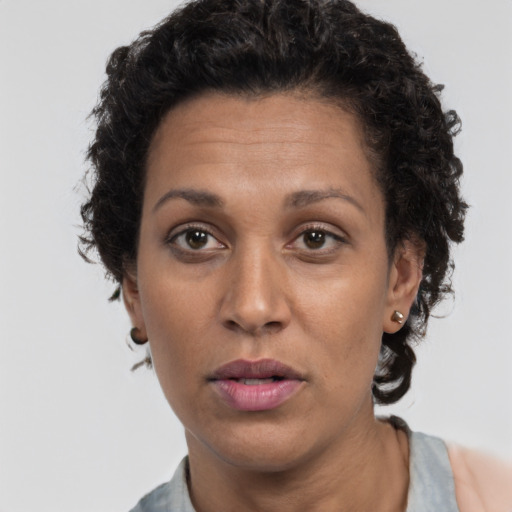 Neutral latino adult female with short  brown hair and brown eyes
