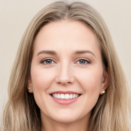 Joyful white young-adult female with long  brown hair and green eyes