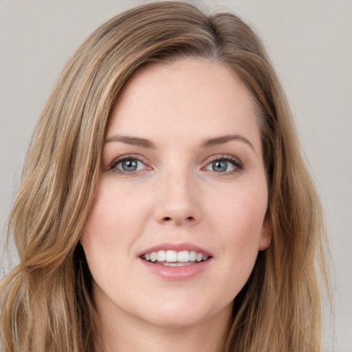 Joyful white young-adult female with long  brown hair and grey eyes