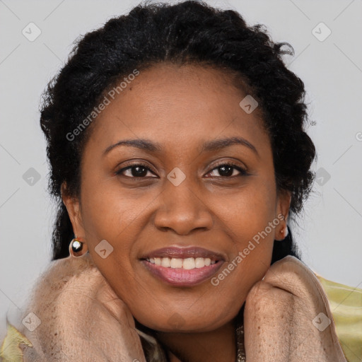 Joyful black adult female with long  brown hair and brown eyes