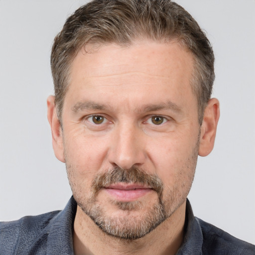 Joyful white adult male with short  brown hair and brown eyes