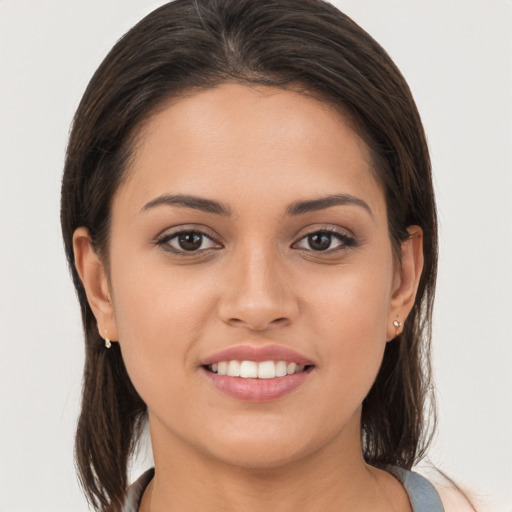 Joyful white young-adult female with long  brown hair and brown eyes