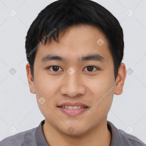 Joyful asian young-adult male with short  black hair and brown eyes