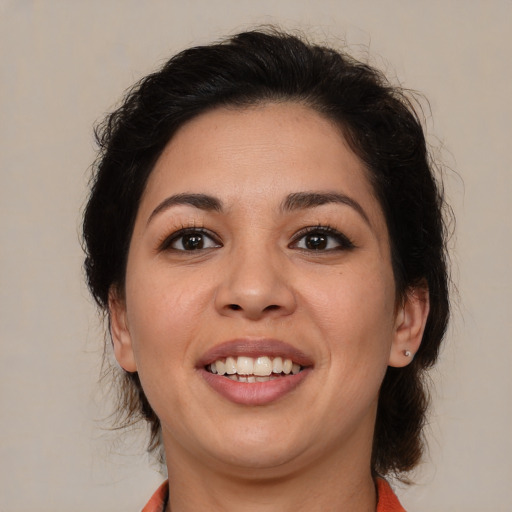 Joyful latino young-adult female with medium  brown hair and brown eyes