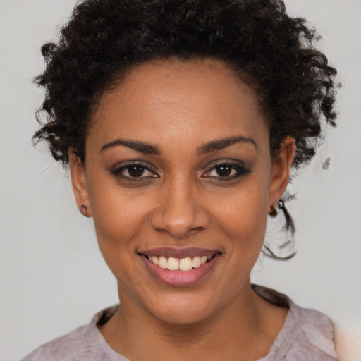 Joyful black young-adult female with short  brown hair and brown eyes