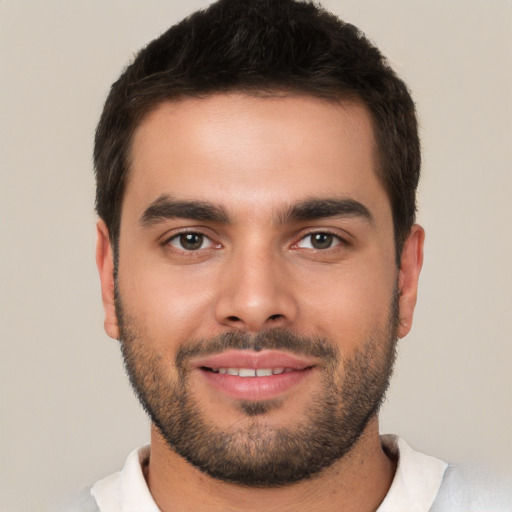 Joyful white young-adult male with short  brown hair and brown eyes