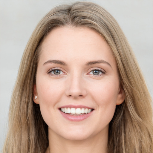 Joyful white young-adult female with long  brown hair and blue eyes