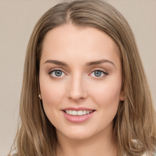 Joyful white young-adult female with long  brown hair and green eyes