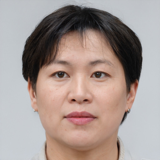 Joyful asian adult female with short  brown hair and brown eyes