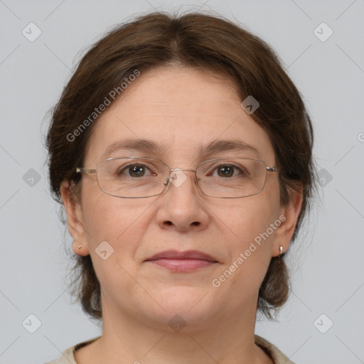 Joyful white adult female with medium  brown hair and grey eyes