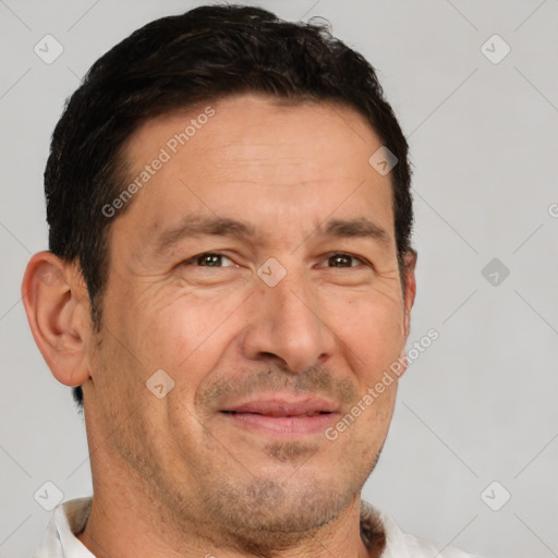 Joyful white adult male with short  brown hair and brown eyes