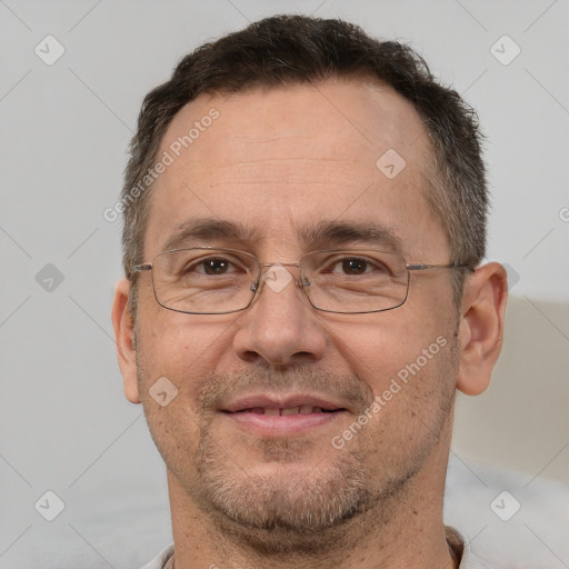 Joyful white adult male with short  brown hair and brown eyes