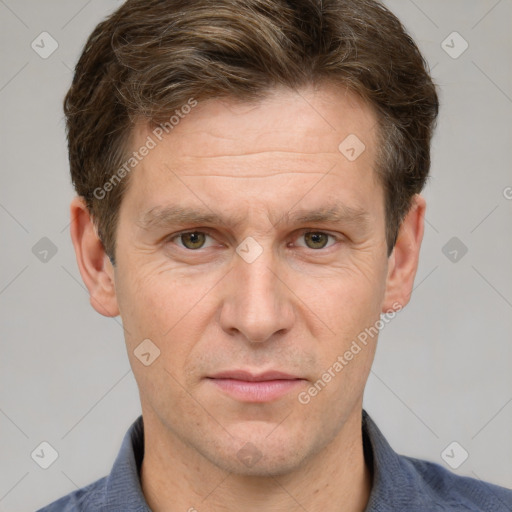 Joyful white adult male with short  brown hair and grey eyes