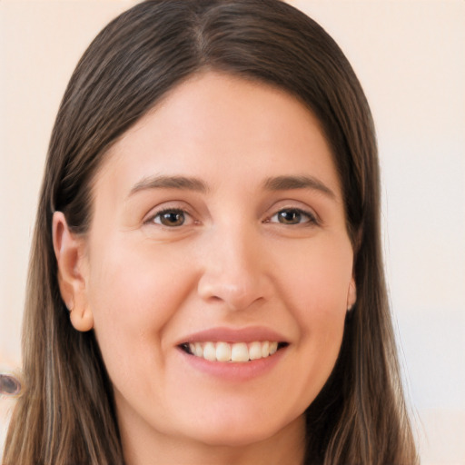 Joyful white young-adult female with long  brown hair and brown eyes