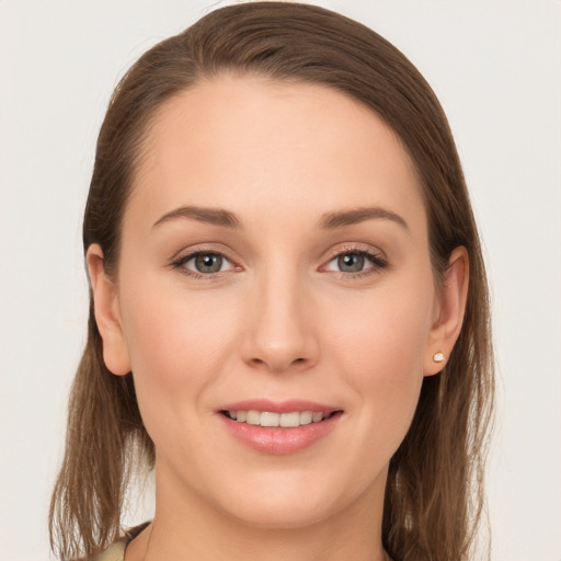 Joyful white young-adult female with long  brown hair and grey eyes