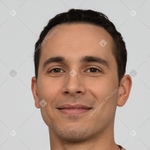 Joyful white young-adult male with short  black hair and brown eyes