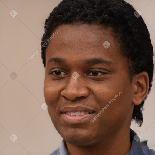 Joyful black young-adult male with short  black hair and brown eyes