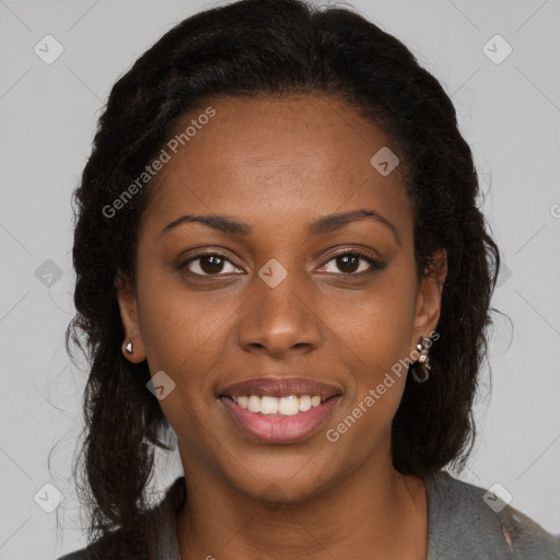 Joyful black young-adult female with long  brown hair and brown eyes