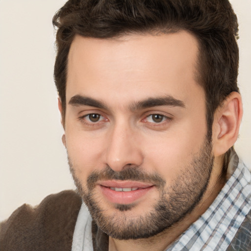 Joyful white adult male with short  brown hair and brown eyes