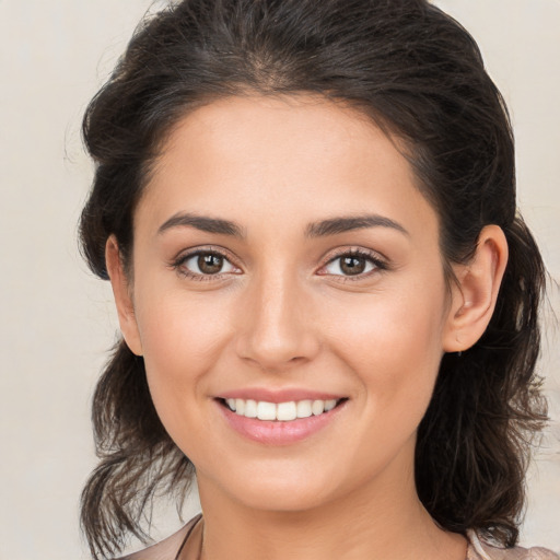 Joyful white young-adult female with medium  brown hair and brown eyes