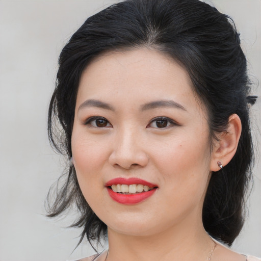 Joyful asian young-adult female with medium  brown hair and brown eyes