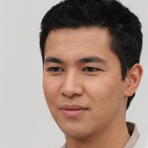 Joyful asian young-adult male with short  black hair and brown eyes