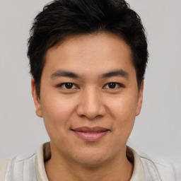 Joyful latino young-adult male with short  brown hair and brown eyes