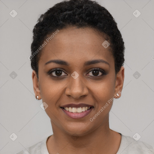 Joyful black young-adult female with short  black hair and brown eyes