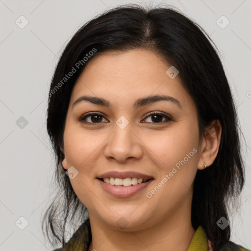 Joyful latino young-adult female with medium  brown hair and brown eyes