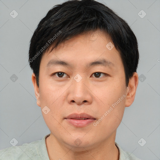 Joyful asian young-adult male with short  black hair and brown eyes